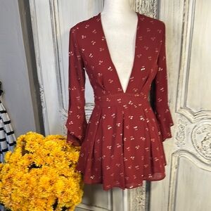 Ruby Red Ruffled Sheer Romper with Plunge Neckline and Statement Sleeves